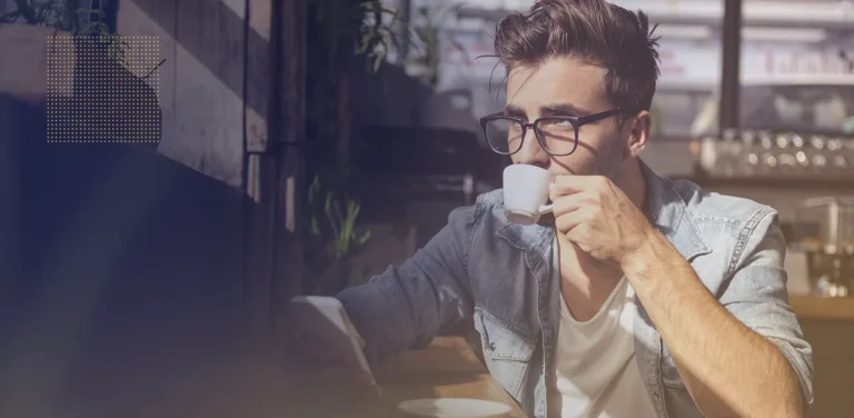 A man drinking from a teacup.
